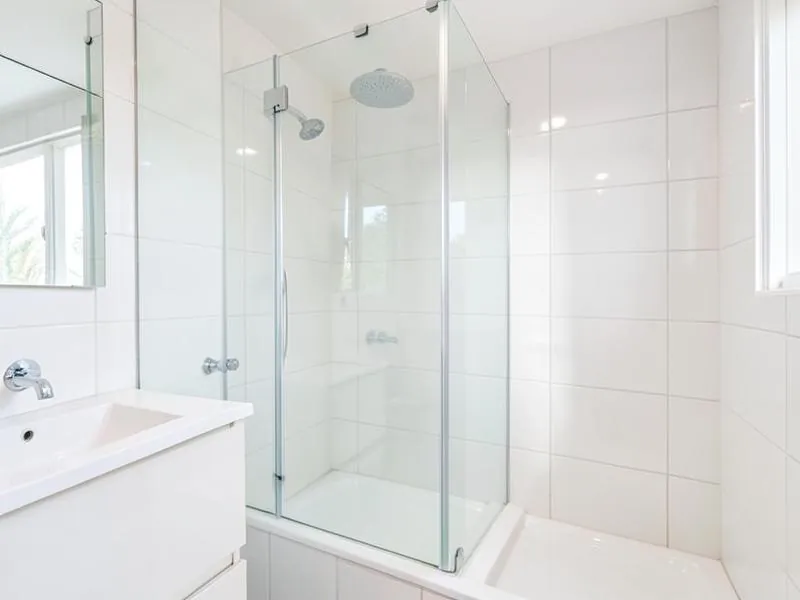 Clean bathroom shower screen and vanity in a rental property